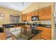Kitchen features black appliances, dark granite counters, and lots of cabinet space at 1770 W Browning Way, Chandler, AZ 85286