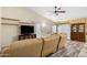 Living room showcasing neutral walls, laminate floors, and a ceiling fan for comfort at 1770 W Browning Way, Chandler, AZ 85286