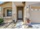 Inviting front entrance with textured walls, an arched doorway, and desert landscaping at 1813 N Lewis Pl, Casa Grande, AZ 85122