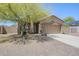 Charming single-story home featuring a well-maintained front yard, desert landscaping and a two-car garage at 1813 N Lewis Pl, Casa Grande, AZ 85122