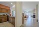Open kitchen view leading to living area and featuring wood cabinets and tile flooring at 1813 N Lewis Pl, Casa Grande, AZ 85122