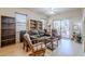 Cozy living room with comfortable seating, built-in shelving, and a sliding glass door at 1813 N Lewis Pl, Casa Grande, AZ 85122