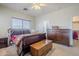Spacious bedroom features a ceiling fan, dresser, and walk-in closet for ample storage at 1813 N Lewis Pl, Casa Grande, AZ 85122