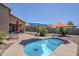 Backyard features a relaxing pool area with gravel landscaping, brick patio, and shade umbrellas at 1813 N Lewis Pl, Casa Grande, AZ 85122