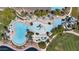 Aerial view of community pools featuring multiple swimming areas, lounge chairs, and poolside amenities at 18371 W Sunrise Dr, Goodyear, AZ 85338