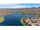 Aerial view of homes surrounding a scenic lake, offering a serene and picturesque living environment at 18371 W Sunrise Dr, Goodyear, AZ 85338