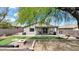 Large backyard with a covered patio, fire pit, hammock, and putting green at 18371 W Sunrise Dr, Goodyear, AZ 85338
