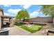 Spacious backyard with synthetic grass, fire pit, putting green, and covered patio at 18371 W Sunrise Dr, Goodyear, AZ 85338