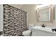 Bathroom with a shower, toilet, vanity with mirror and geometric shower curtain at 18371 W Sunrise Dr, Goodyear, AZ 85338