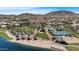 Aerial view shows lakefront beach with playground, tennis and volleyball courts, and picnic areas at 18371 W Sunrise Dr, Goodyear, AZ 85338