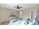 Comfortable bedroom featuring a ceiling fan and view of the ensuite bathroom at 18371 W Sunrise Dr, Goodyear, AZ 85338
