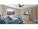Cozy bedroom with a ceiling fan, dresser, plush bed and a large window, offering a comfortable retreat at 18371 W Sunrise Dr, Goodyear, AZ 85338
