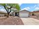 Charming single-story home featuring a two car garage, desert landscaping, and a welcoming entryway at 18371 W Sunrise Dr, Goodyear, AZ 85338