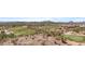 Scenic aerial view of golf course with verdant greens, desert landscaping, and mountain backdrop at 18371 W Sunrise Dr, Goodyear, AZ 85338