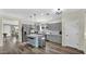 Modern kitchen featuring stainless steel appliances, gray cabinets, and an island with barstool seating at 18371 W Sunrise Dr, Goodyear, AZ 85338