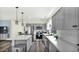 Modern kitchen featuring stainless steel appliances, gray cabinets, and a stylish island with pendant lighting at 18371 W Sunrise Dr, Goodyear, AZ 85338