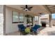 Relaxing covered patio with fan, seating, and grill, perfect for outdoor entertaining at 18371 W Sunrise Dr, Goodyear, AZ 85338