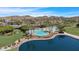 Stunning view of community pools, palm trees, manicured lawns, and lake access for leisure and recreation at 18371 W Sunrise Dr, Goodyear, AZ 85338