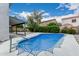 Backyard features a pool covered with a net, a covered patio area, and landscaped surroundings at 1898 E Kent Ave, Chandler, AZ 85225