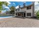 Exterior of home showcasing a covered patio, a pool with a net, and a low-maintenance yard at 1898 E Kent Ave, Chandler, AZ 85225