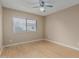 A bedroom featuring light hardwood floors, a ceiling fan, and a large window at 1898 E Kent Ave, Chandler, AZ 85225