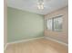 Bedroom featuring green and beige walls, light wood floors and a ceiling fan at 1898 E Kent Ave, Chandler, AZ 85225