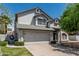 Charming two-story home featuring a well-manicured lawn and an attached two-car garage at 1898 E Kent Ave, Chandler, AZ 85225