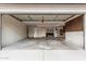 Spacious garage with concrete floors and walls, an open garage door, and an interior door at 1898 E Kent Ave, Chandler, AZ 85225