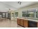 Bright kitchen features wood cabinets, laminate countertops and black appliances with view to the outside at 1898 E Kent Ave, Chandler, AZ 85225