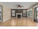 Cozy living room featuring hardwood floors, a fireplace, and sliding door to the patio at 1898 E Kent Ave, Chandler, AZ 85225