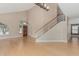 Open-concept living room featuring hardwood floors, a staircase, and bright windows at 1898 E Kent Ave, Chandler, AZ 85225