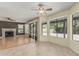 Inviting living room with hardwood floors, a ceiling fan, and a cozy fireplace at 1898 E Kent Ave, Chandler, AZ 85225