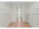Spacious walk-in closet with built-in shelving and wood laminate floors at 1898 E Kent Ave, Chandler, AZ 85225