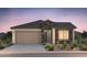 Charming single-story home boasting stone accents, a two-car garage, and well-maintained desert landscaping at 21254 E Cattle Dr, Queen Creek, AZ 85142