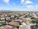 Expansive aerial view of a community with pools, landscaping and mountain range backdrop at 22274 E Cherrywood Ct, Queen Creek, AZ 85142