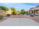 Expansive backyard with lush greenery, a patio area, and ample space for outdoor activities at 22274 E Cherrywood Ct, Queen Creek, AZ 85142