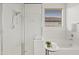 Bright primary bathroom with a glass-enclosed shower and soaking tub by the window at 22274 E Cherrywood Ct, Queen Creek, AZ 85142