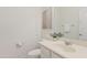 Neutral half-bathroom featuring vanity, mirror, and toilet with coordinating decor at 22274 E Cherrywood Ct, Queen Creek, AZ 85142