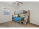 Neutral bedroom featuring a bunk bed with staircase and ceiling fan, providing a cozy space at 22274 E Cherrywood Ct, Queen Creek, AZ 85142