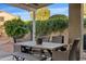 Charming covered patio with an outdoor dining area, perfect for enjoying outdoor meals at 22274 E Cherrywood Ct, Queen Creek, AZ 85142