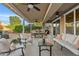 Comfortable covered patio with plush seating, a dining area, and a ceiling fan for relaxed outdoor living at 22274 E Cherrywood Ct, Queen Creek, AZ 85142
