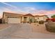 Charming single-story home with a well-manicured lawn and a two-car garage at 22274 E Cherrywood Ct, Queen Creek, AZ 85142