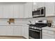 Kitchen with white cabinets, stainless steel appliances, and modern countertops at 22274 E Cherrywood Ct, Queen Creek, AZ 85142