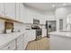 Modern white kitchen featuring updated appliances, bright countertops and tile floors at 22274 E Cherrywood Ct, Queen Creek, AZ 85142