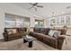 Spacious living room featuring a large sectional sofa, ceiling fan, and an open floor plan at 22274 E Cherrywood Ct, Queen Creek, AZ 85142