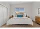 Primary bedroom with neutral tones, large window, and matching end tables at 22274 E Cherrywood Ct, Queen Creek, AZ 85142