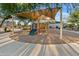 Playground with slides and climbing equipment under a shade canopy at 22274 E Cherrywood Ct, Queen Creek, AZ 85142