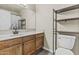 This is a well-lit bathroom including dark wood shelving at 2247 W Highland St, Chandler, AZ 85224