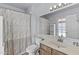 Bright bathroom featuring a single sink, vanity, and shower with a patterned curtain at 2247 W Highland St, Chandler, AZ 85224