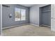 A carpeted bedroom featuring a closet and a view of the outside at 2247 W Highland St, Chandler, AZ 85224